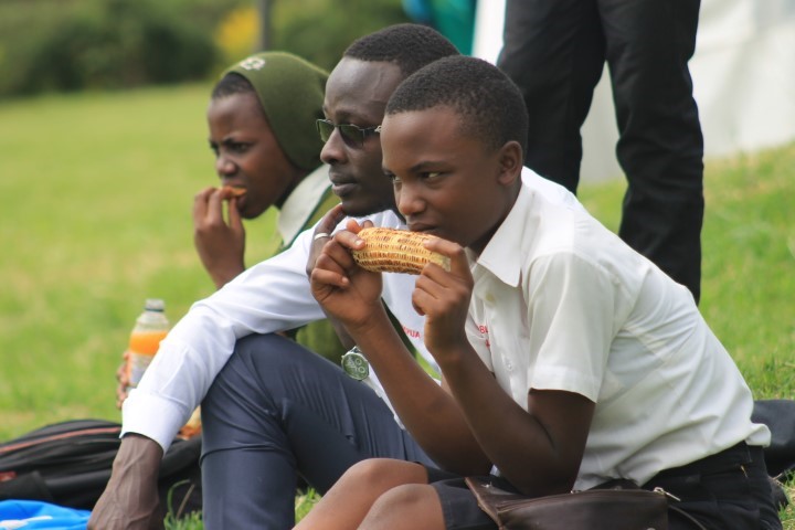 a peer educator eating corn before the function